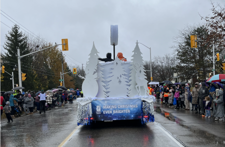 Parade float on the road surrounded by crowds